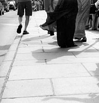 Artistic photograph of feet on a city sidewalk
