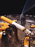 A cigarette burning in an ashtray